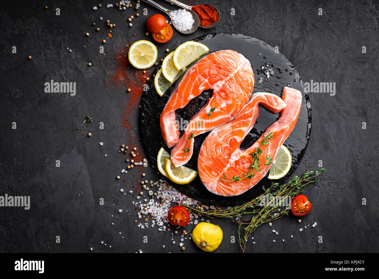 Fresh raw salmon red fish steaks on black background, top view Stock ...