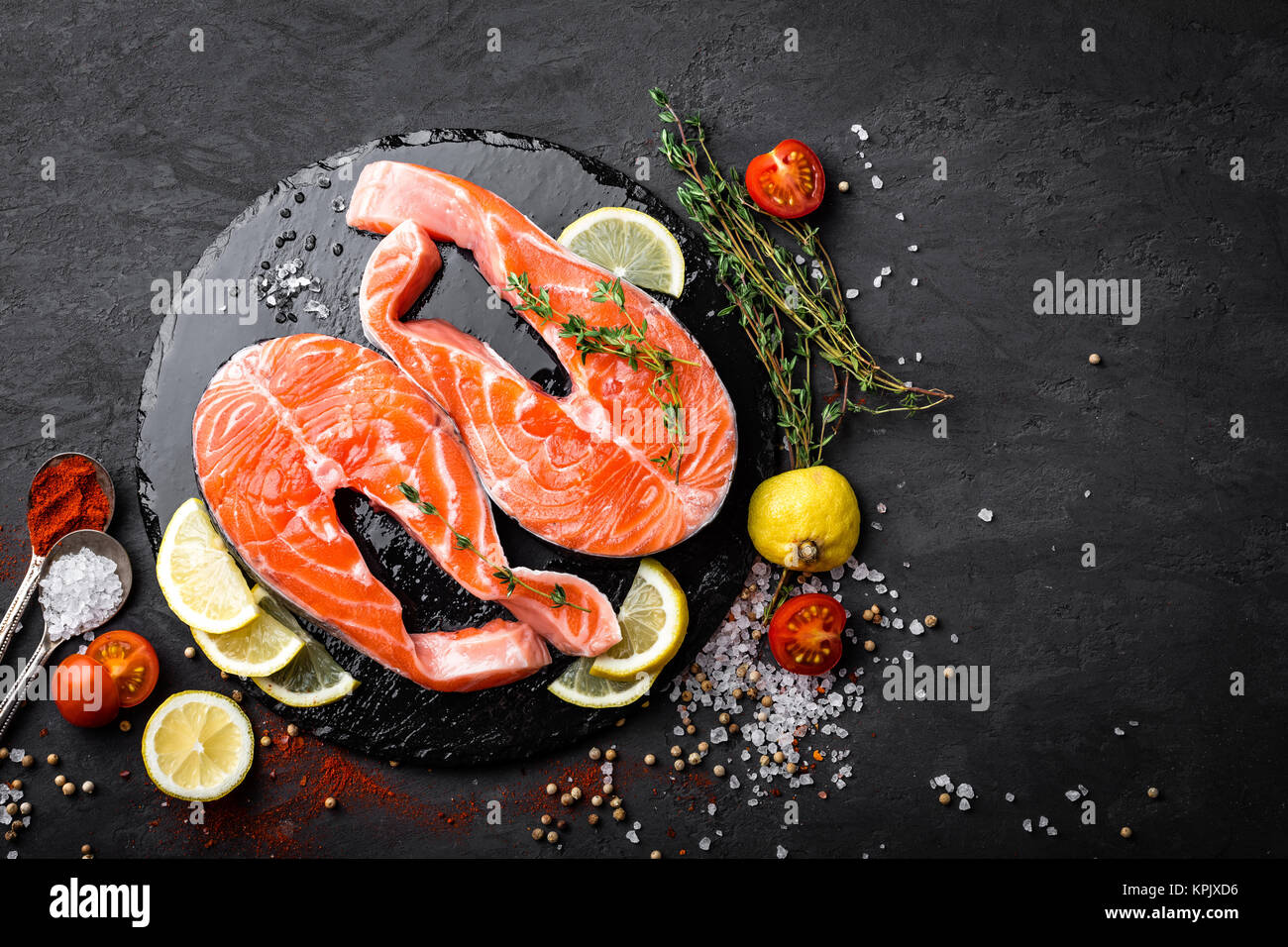 Fresh raw salmon red fish steaks on black background, top view Stock ...