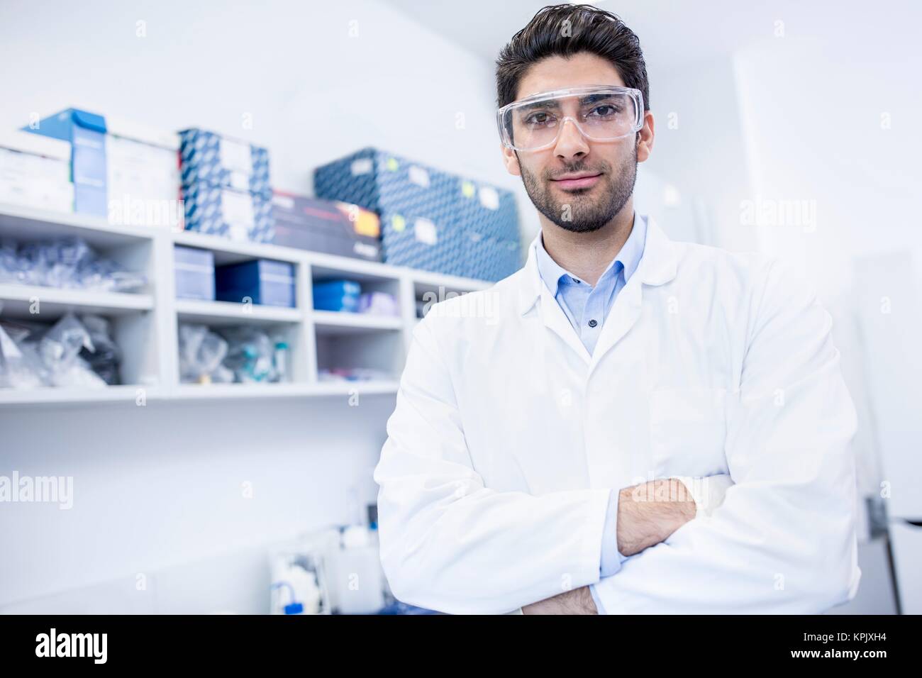 Male laboratory assistant with arms folded, portrait. Stock Photo