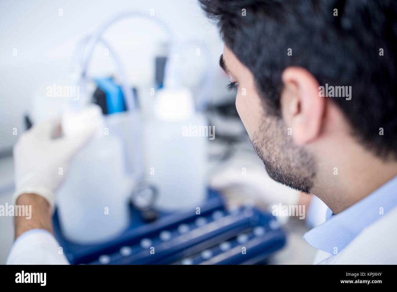Male laboratory assistant using equipment. Stock Photo