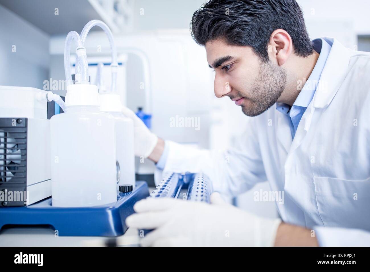 Male laboratory assistant using equipment. Stock Photo