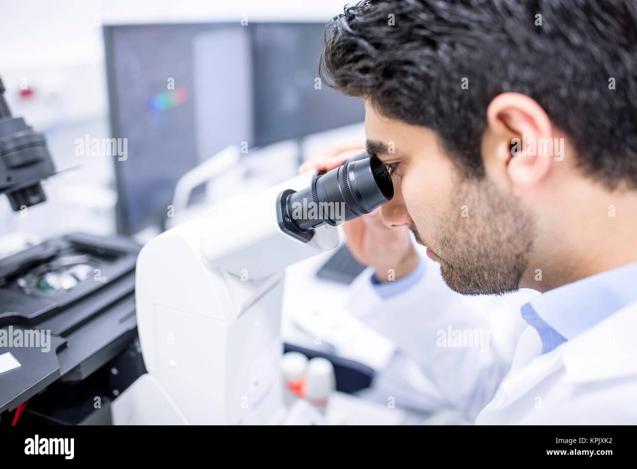 Male scientist using microscope, close up. Stock Photo