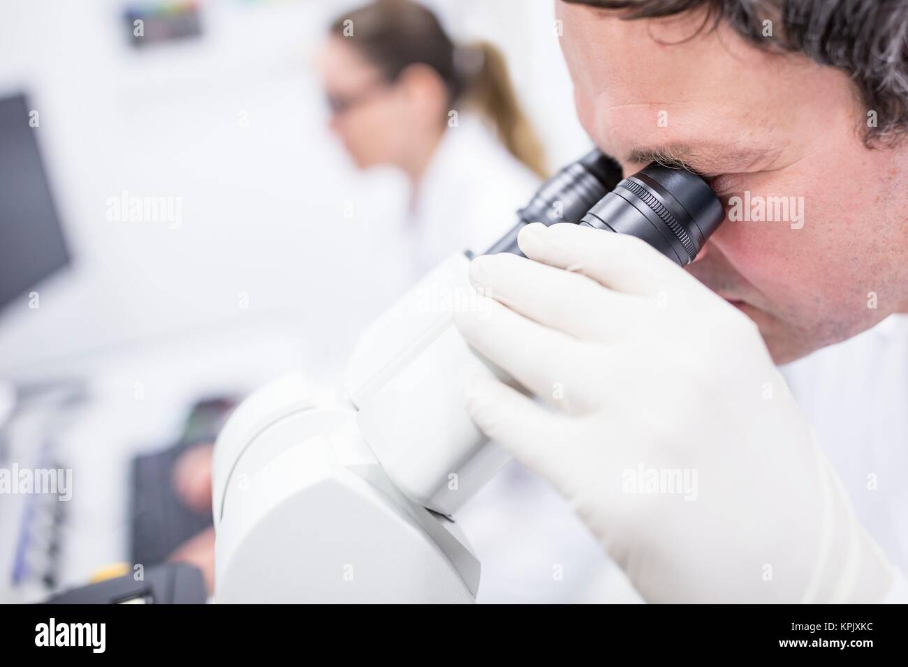 Male scientist using microscope. Stock Photo