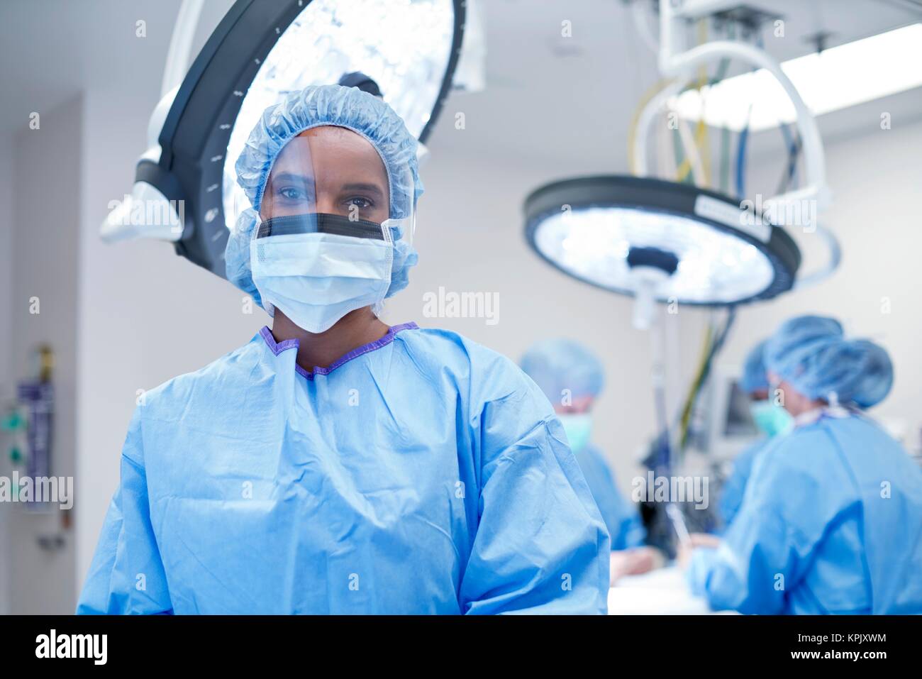 Female surgeon wearing mask and visor, portrait Stock Photo - Alamy