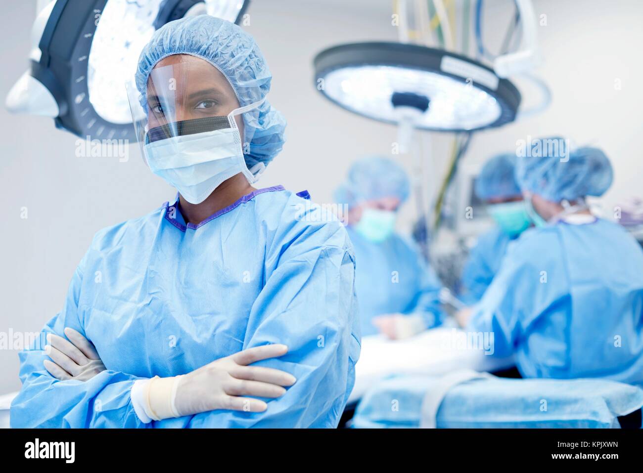 Female surgeon wearing mask and visor, portrait Stock Photo - Alamy