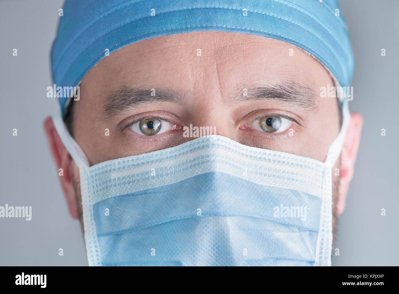 Male doctor wearing surgical mask, close up Stock Photo - Alamy