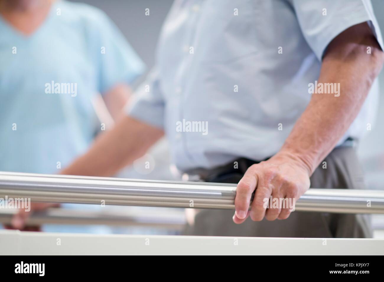 Man using parallel walking bars in hospital Stock Photo Alamy