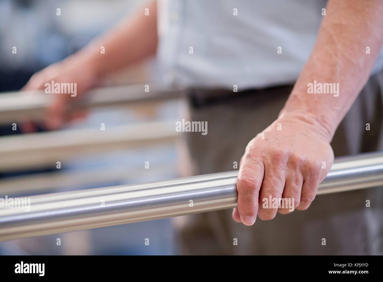 Man using parallel walking bars in hospital Stock Photo Alamy
