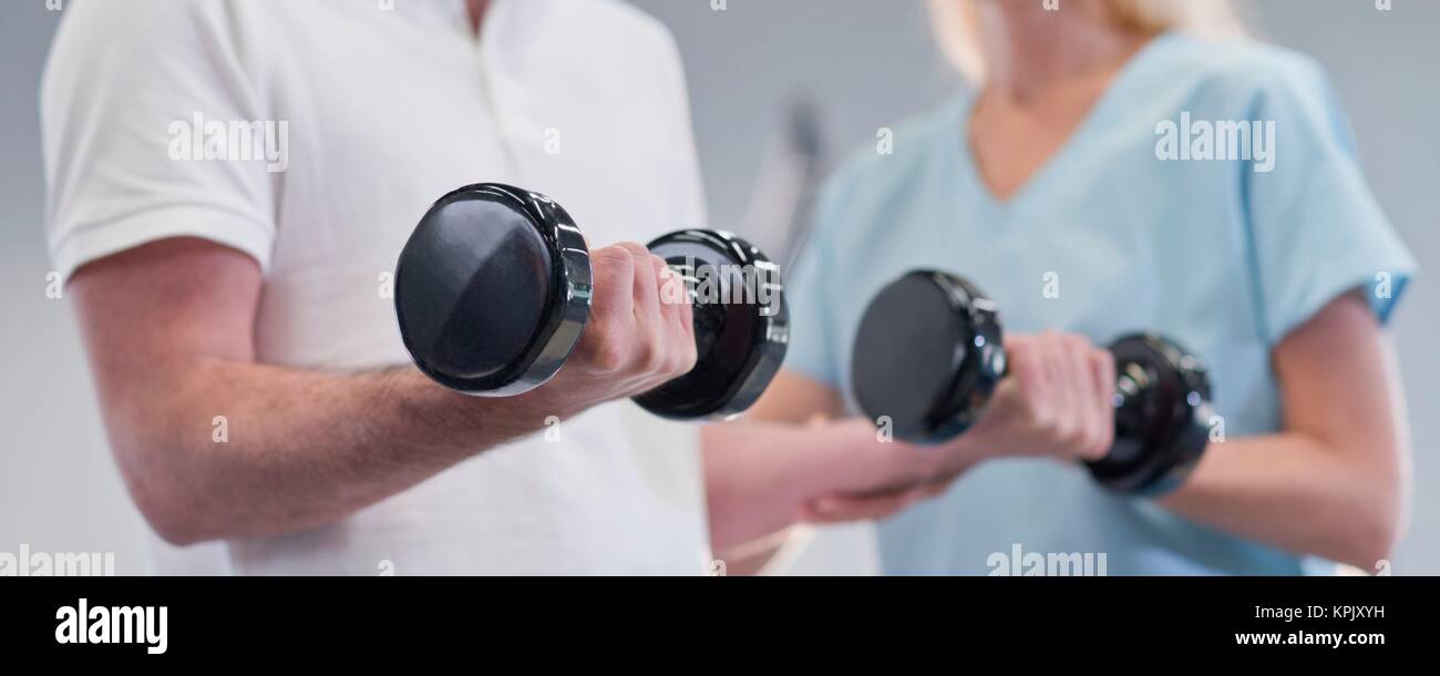 Female Nurse Showing Man How To Use Hand Weights Stock Photo Alamy female-nurse-showing-man-how-to-use-hand-weights-stock-photo-alamy