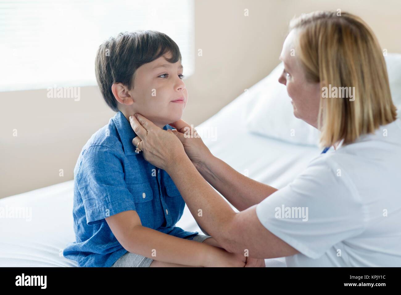 Nurse examining young boy. Stock Photo