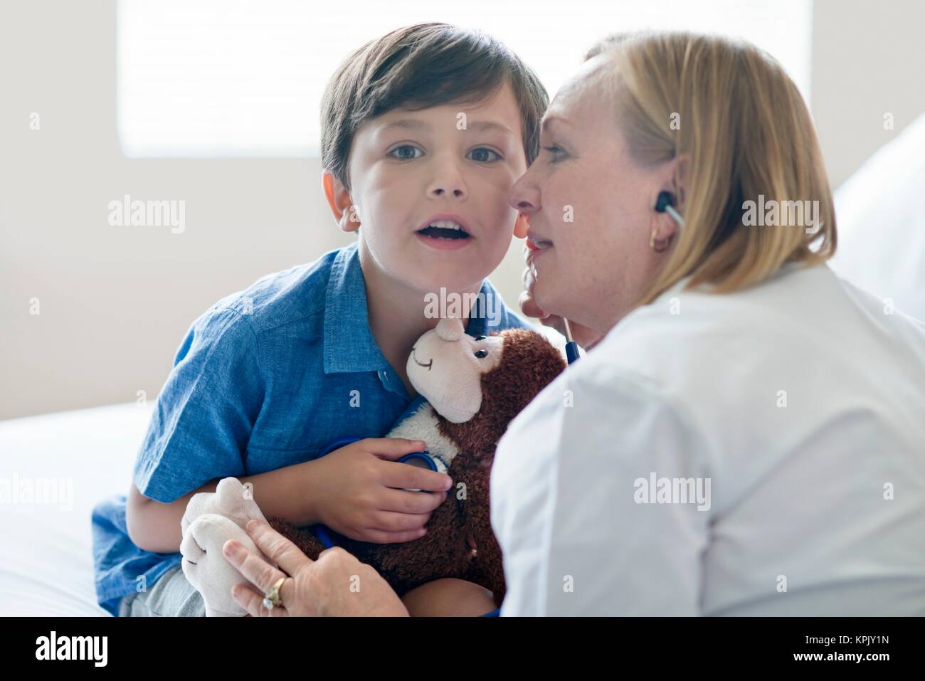 Young boy and nurse listening to stethoscope. Stock Photo