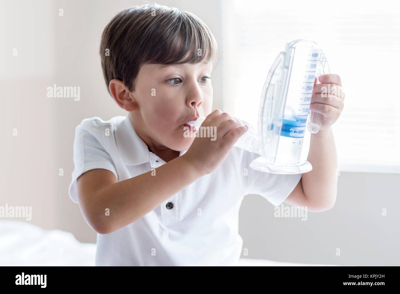 Young boy using breathing equipment. Stock Photo