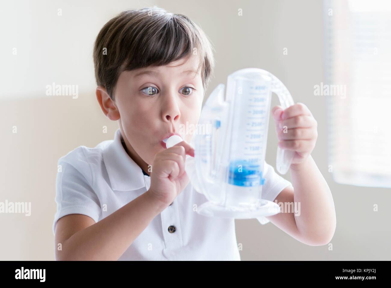 Young boy using breathing equipment. Stock Photo