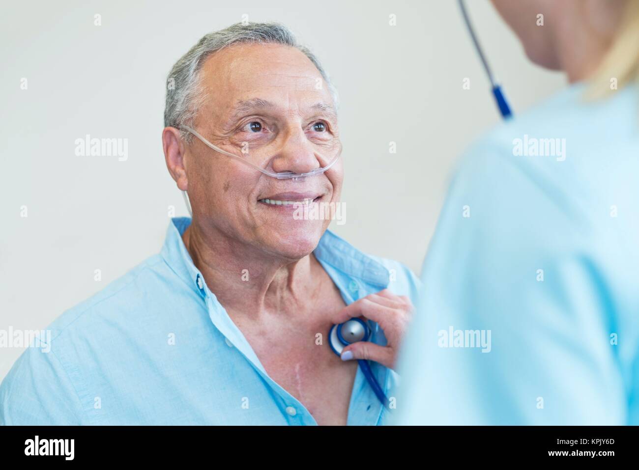 Female doctor examining patient with stethoscope Stock Photo - Alamy
