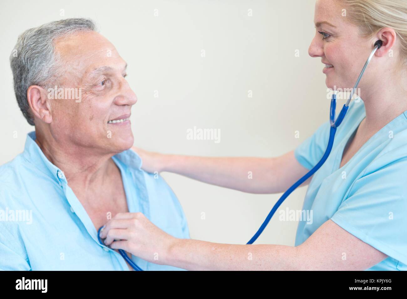 Female doctor examining patient with stethoscope Stock Photo - Alamy
