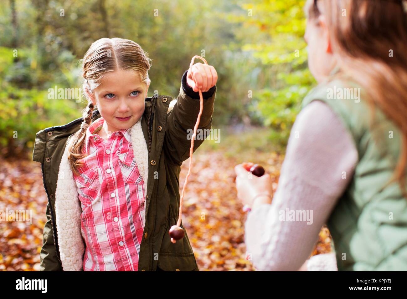 Two girls playing conkers Stock Photo - Alamy