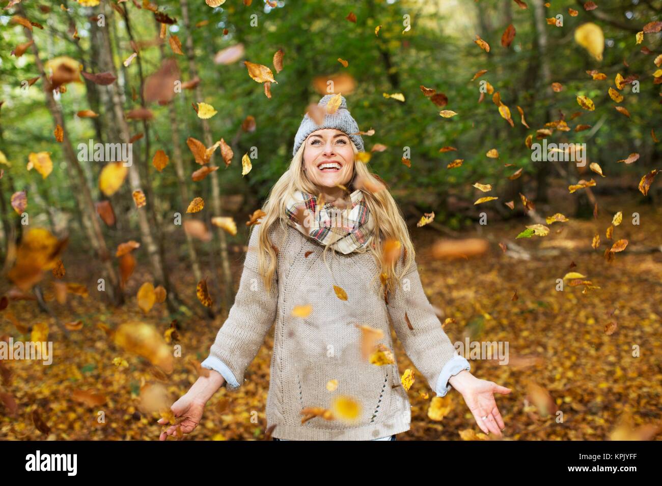 Woman playing in Autumn leaves Stock Photo - Alamy