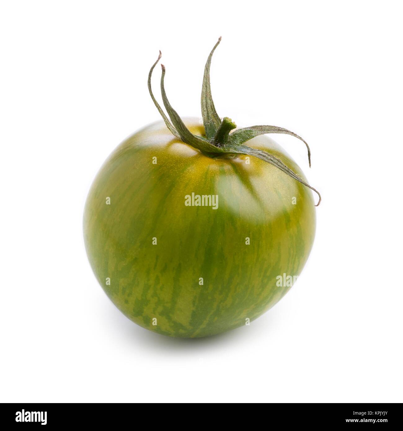 Green tomato against a white background Stock Photo - Alamy