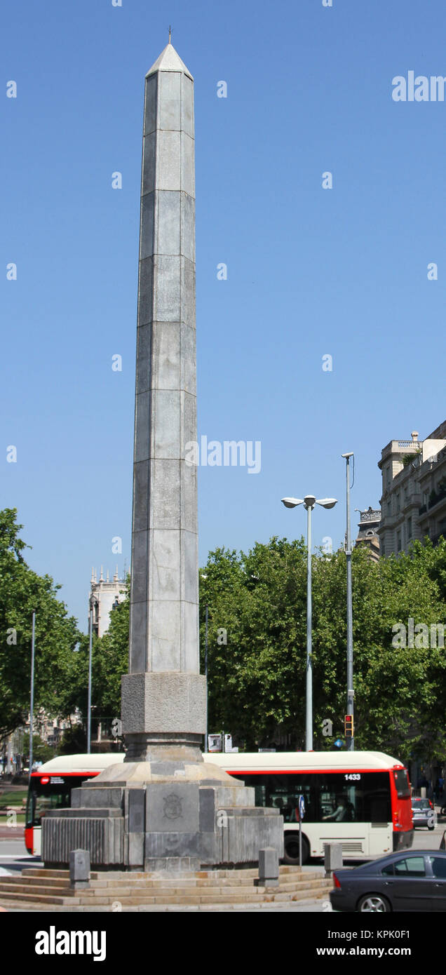Hexagonal obelisk in The Juan Carlos square, Barcelona, Spain. Stock Photo