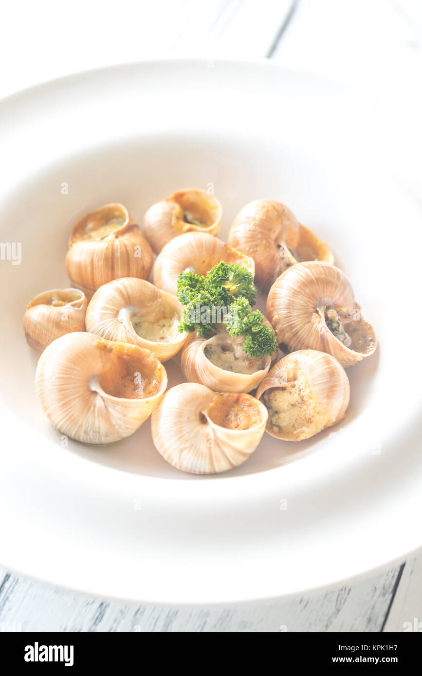 Portion of cooked snails Stock Photo Alamy