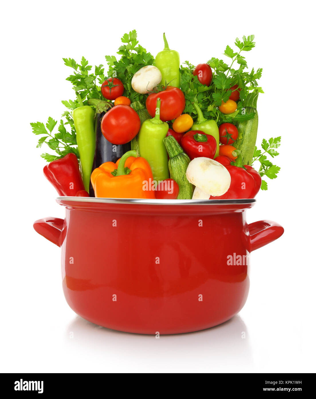 Colorful vegetables in a red cooking pot isolated on white background Stock Photo