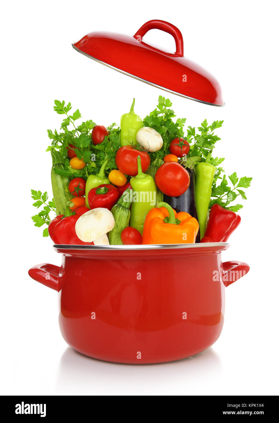 Colorful vegetables in a red cooking pot isolated on white background Stock Photo