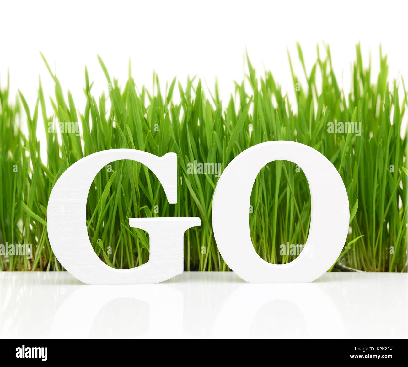 Go green with text and grass isolated on white Stock Photo