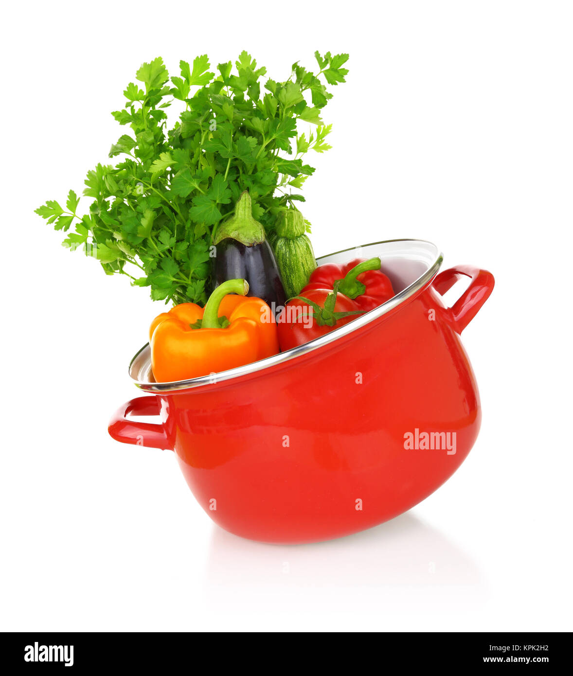 Colorful vegetables in a red cooking pot isolated on white background Stock Photo