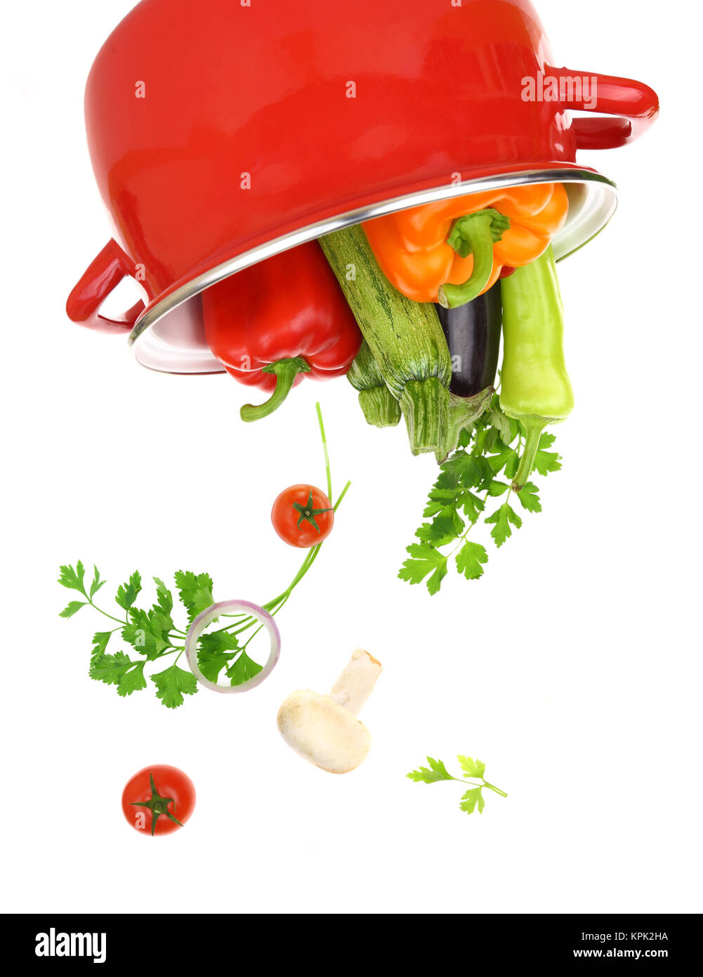 Colorful vegetables in a red cooking pot isolated on white background Stock Photo