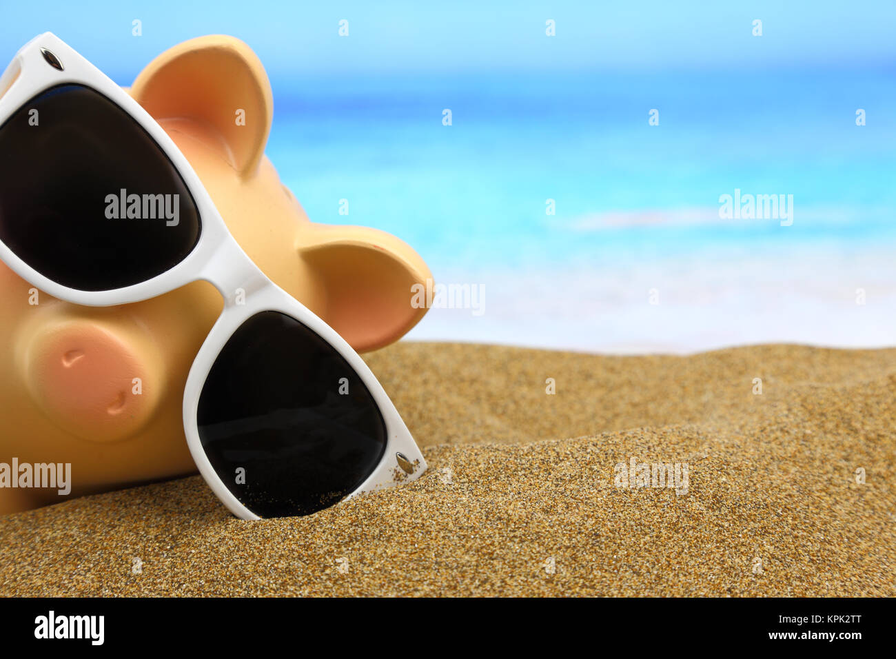 Summer piggy bank with sunglasses on the beach Stock Photo - Alamy
