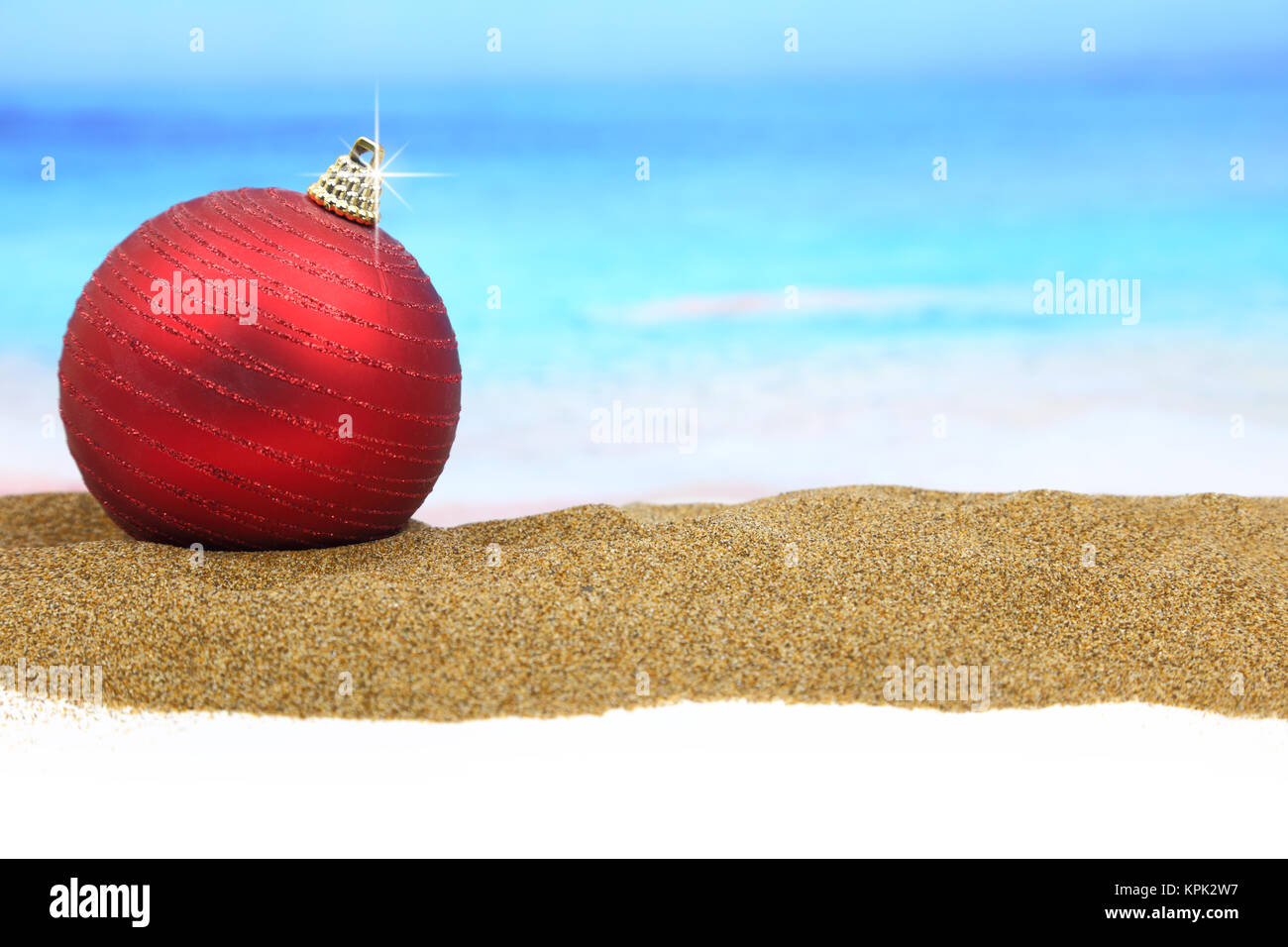 Christmas ball on the beach Stock Photo - Alamy