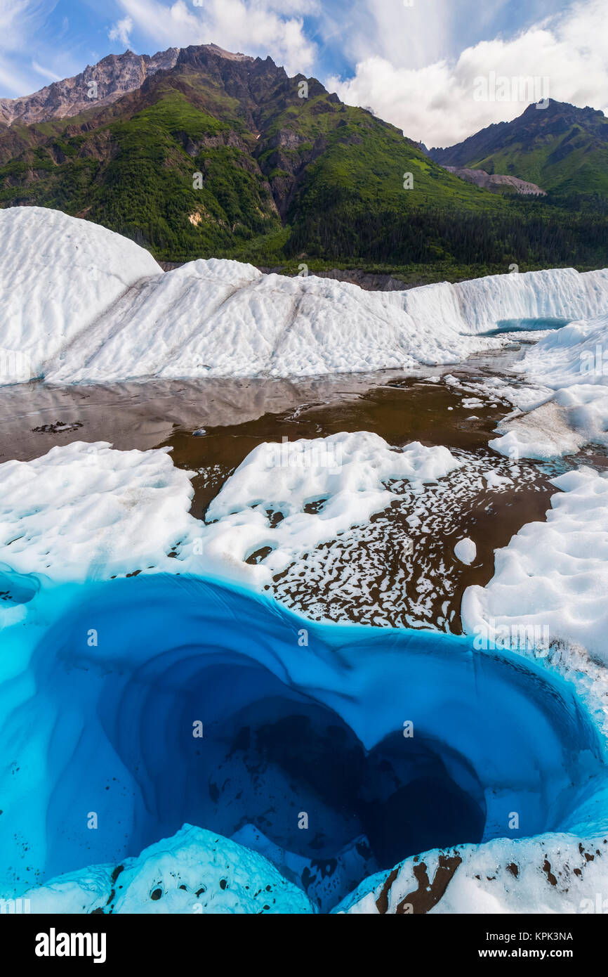 A pool of water on the surface of Root Glacier in Wrangell-St. Elias National Park resembles a heart shape; Alaska, United States of America Stock Photo