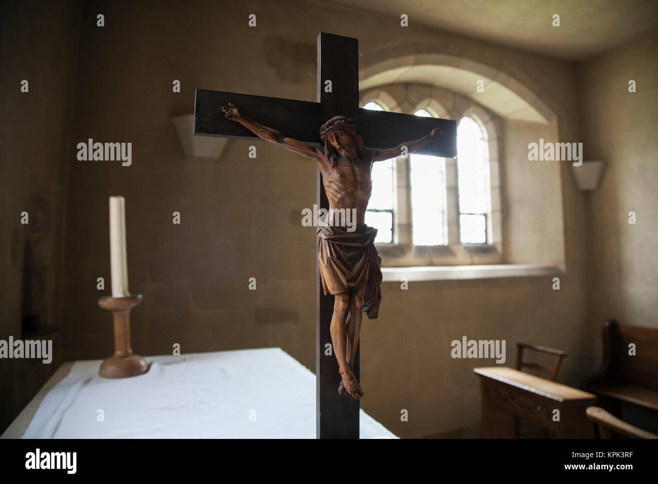 Altartop crucifix in crypt prayer alcove; York, England Stock Photo