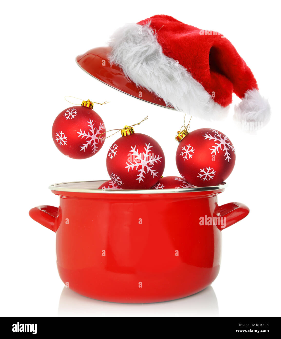 Cooking pot with Christmas ornaments and santas hat Stock Photo