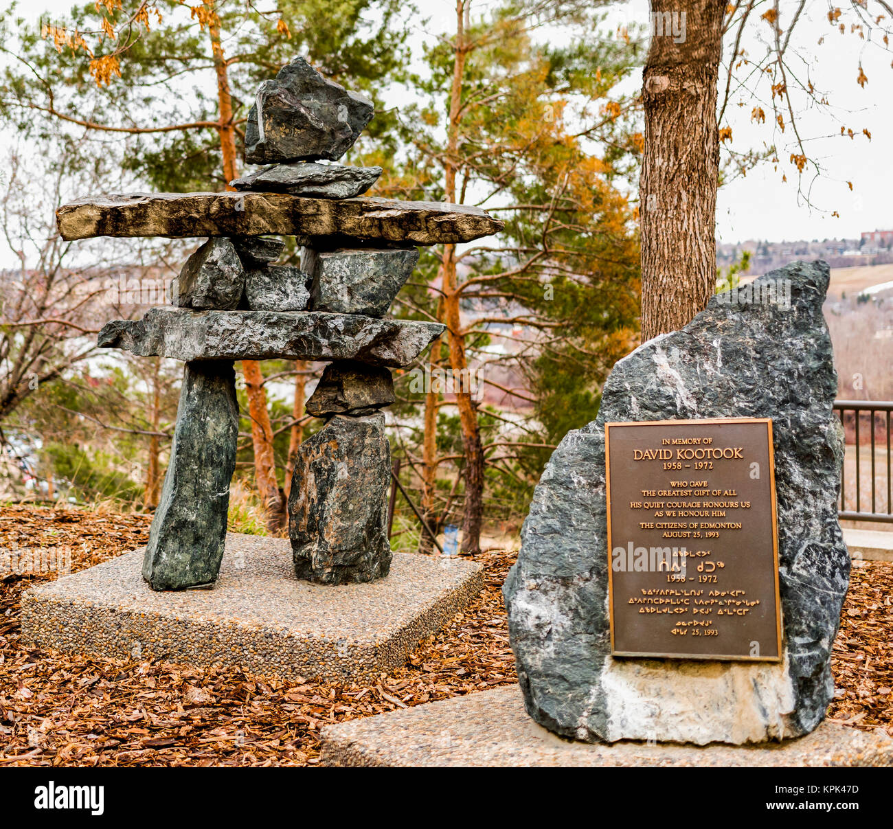 A memorial plaque with inukshuk among some trees in autumn; Edmonton, Alberta, Canada Stock Photo