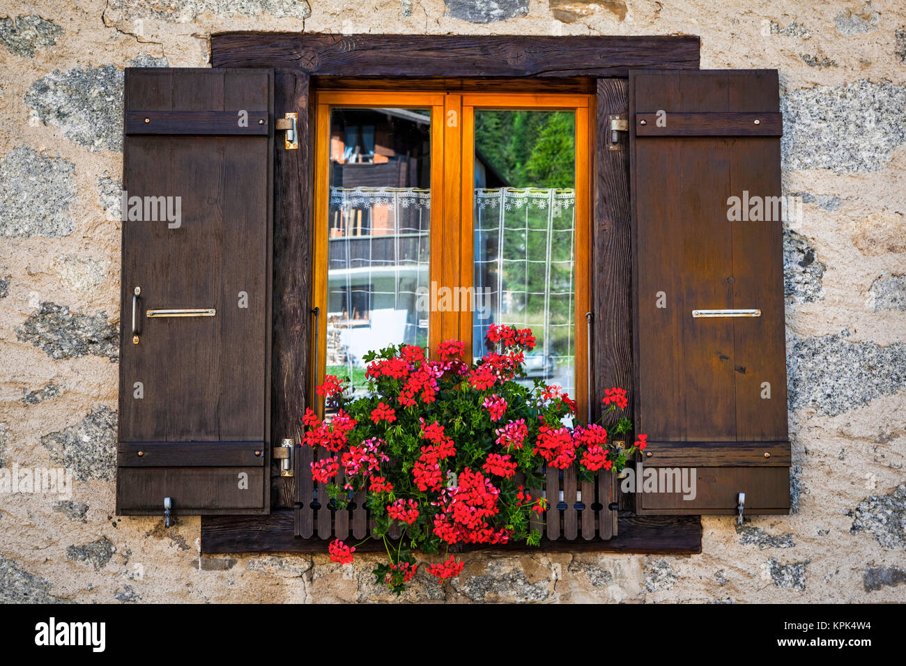 Close-up of Swiss chalet window with flower pot; La Fouly, Val Ferret, Switzerland Stock Photo