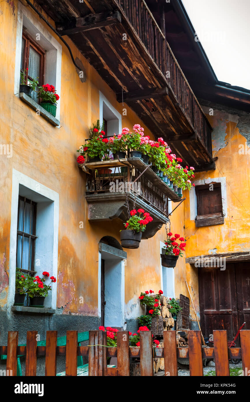 Historic building with flower pots, Dolonne, near Courmayeur; Aosta Valley, Italy Stock Photo
