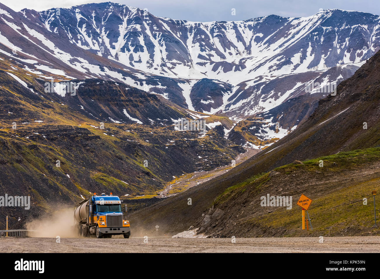 A semi-truck ascends through Atigun Pass along the Dalton Highway; Alaska, United States of America Stock Photo