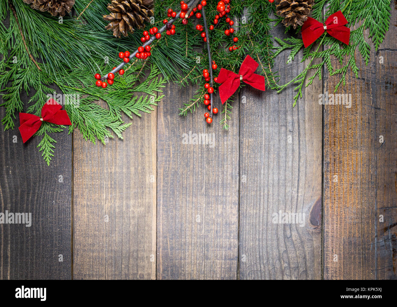 Christmas decorations and fir branches on wooden board background with ...