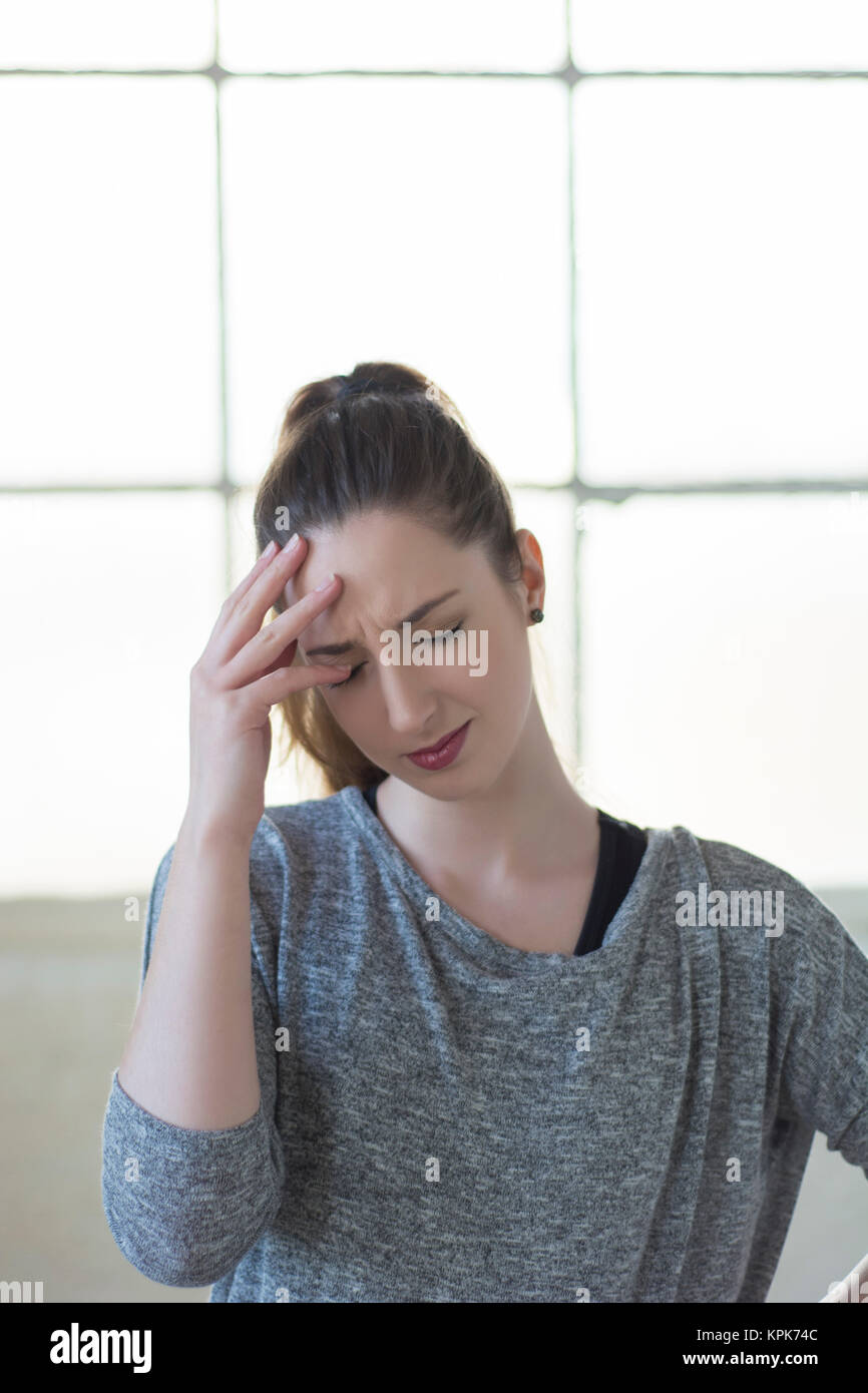 Upset young woman hand on head Stock Photo
