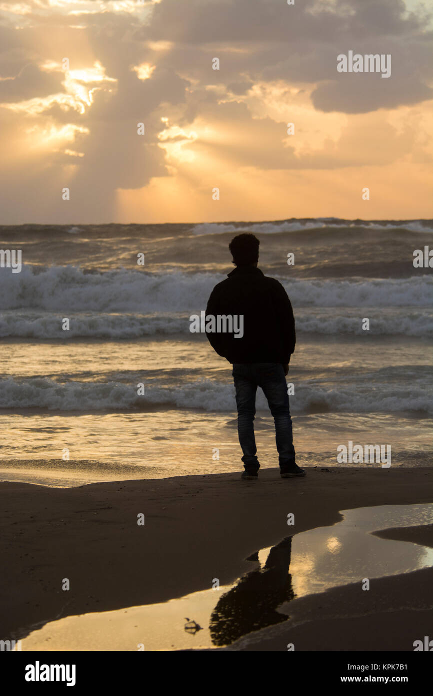 Back view young man silhouette outside hi-res stock photography and ...