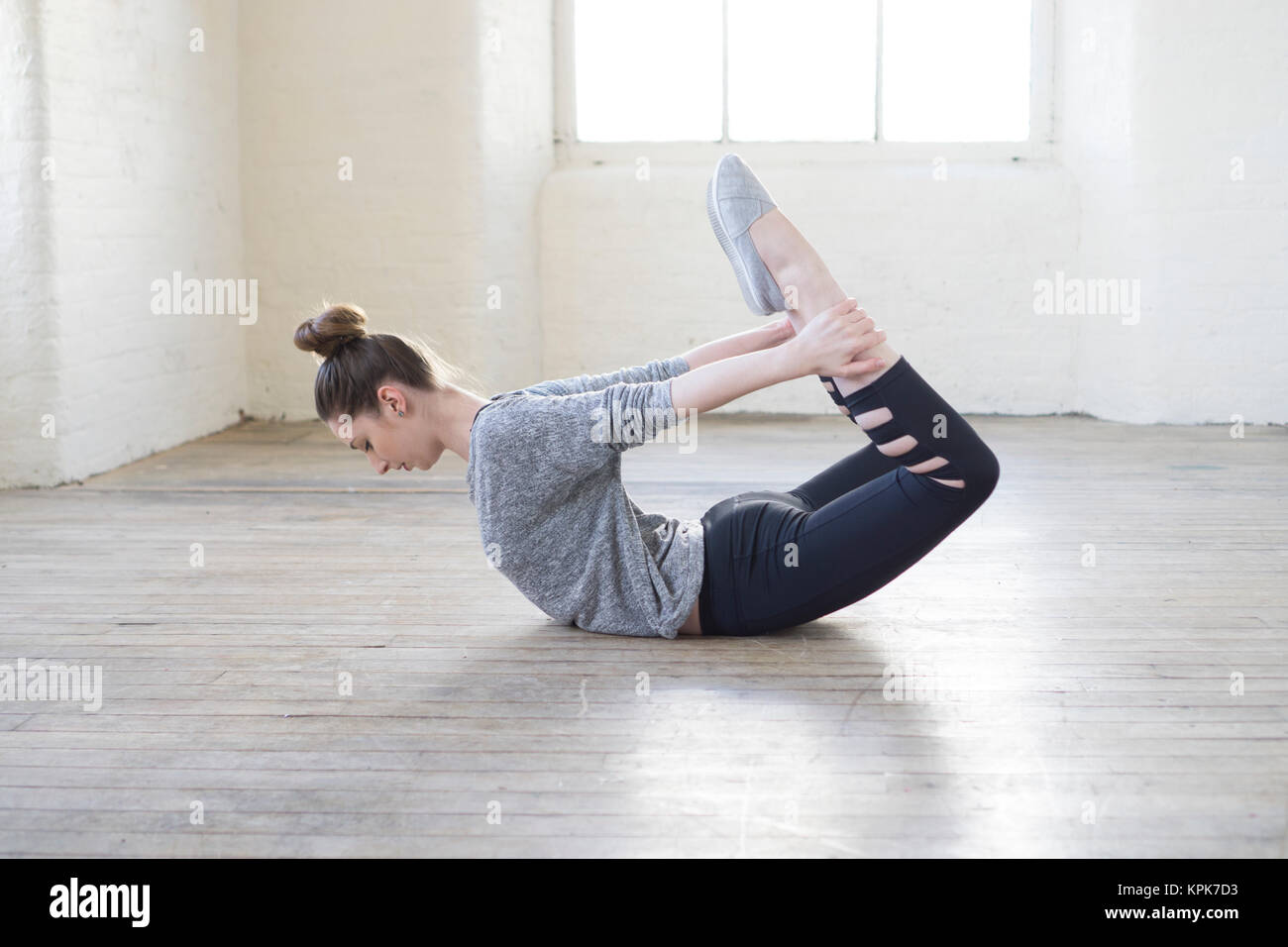 Healthy young woman stretching legs on the floor Stock Photo - Alamy