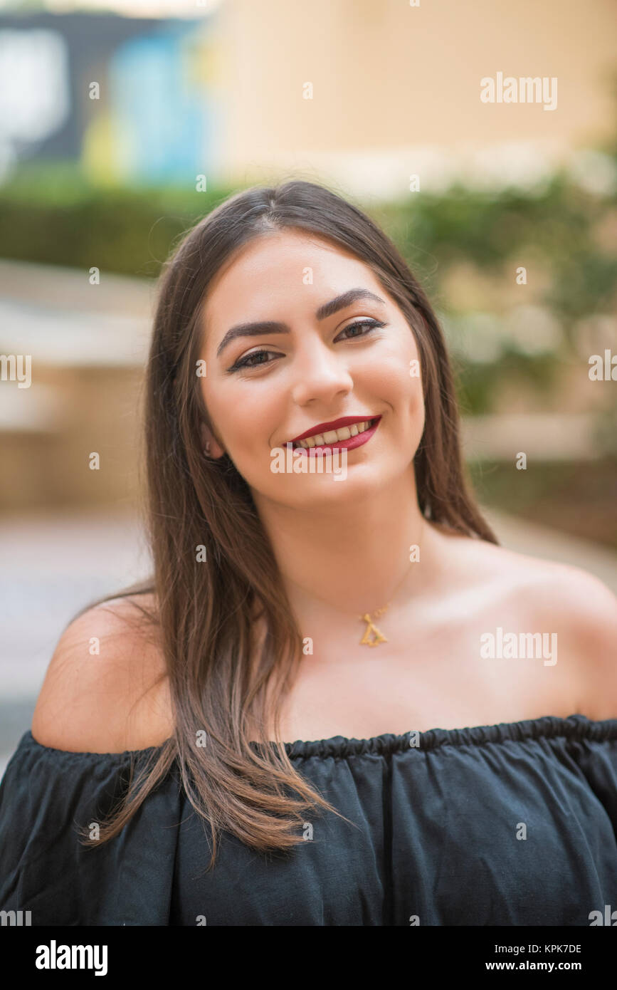 Beautiful young woman smiling outdoors Stock Photo - Alamy