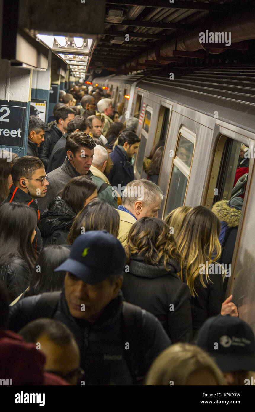 Overly crowded subway train platform during the evening rush hour at