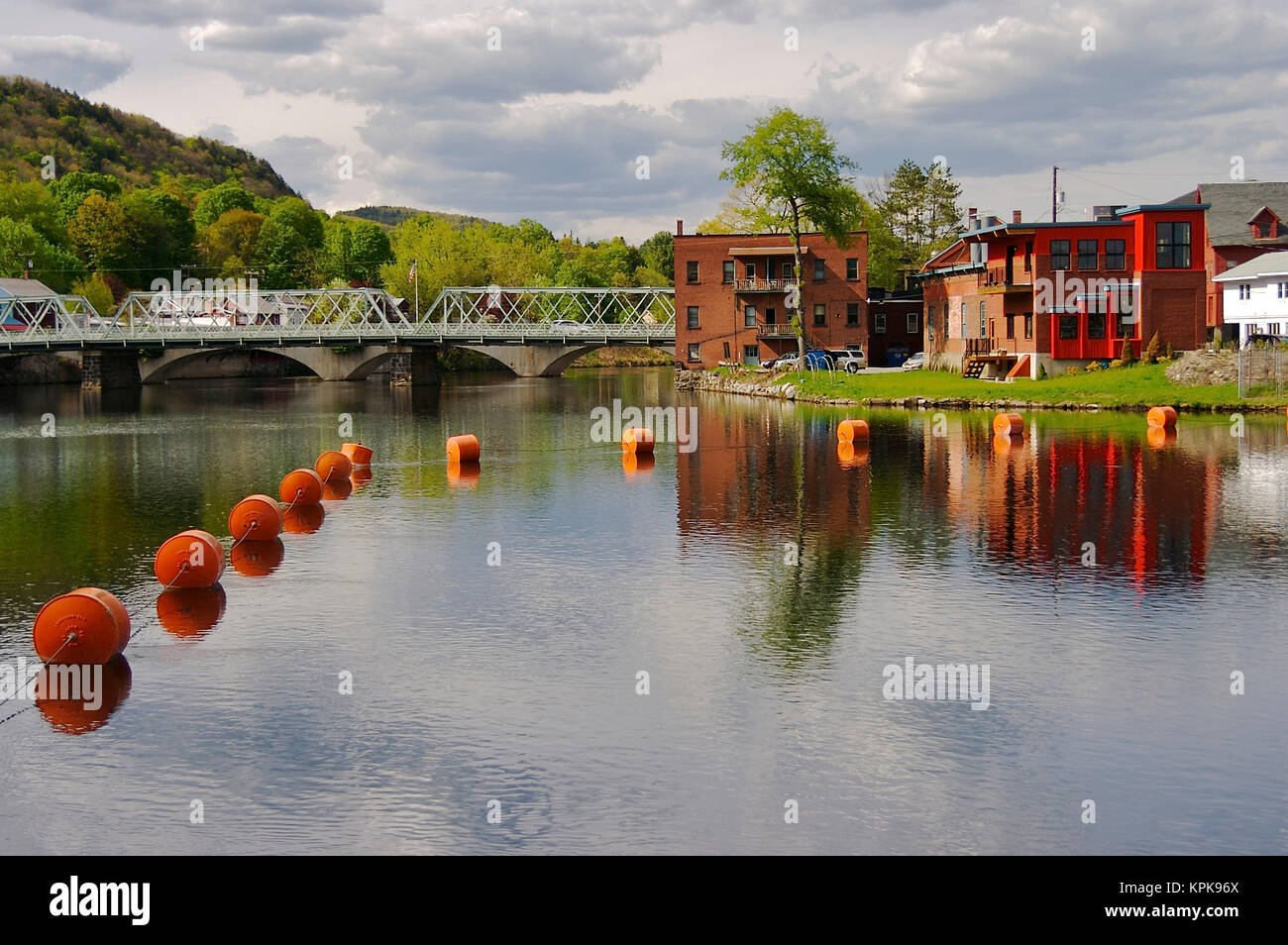 USA, Massachusetts, Shelburne Falls. Looking towards Shelburne Village buildings from across the Deerfield River Stock Photo