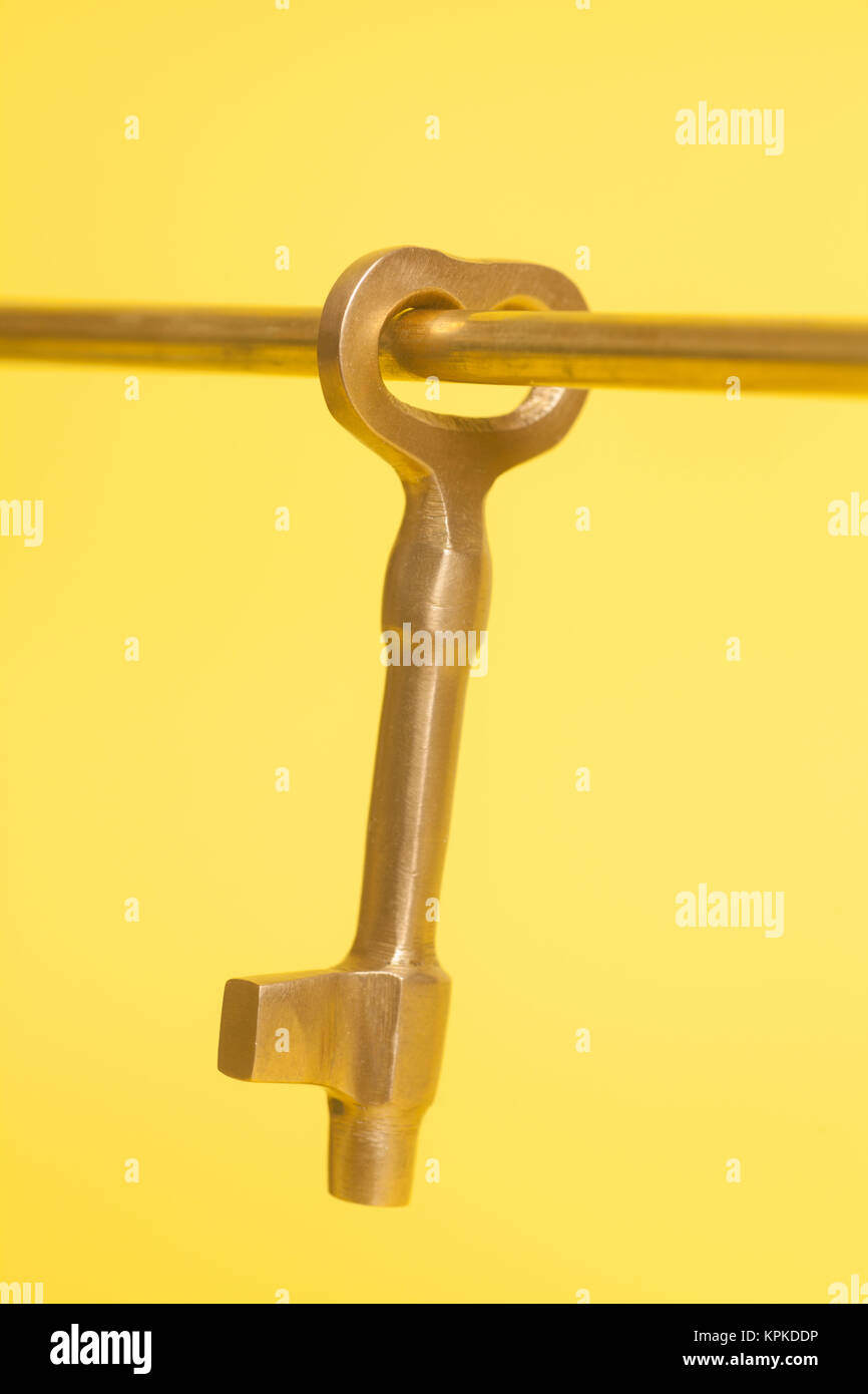 Vintage Key on Tube on a yellow background Stock Photo - Alamy