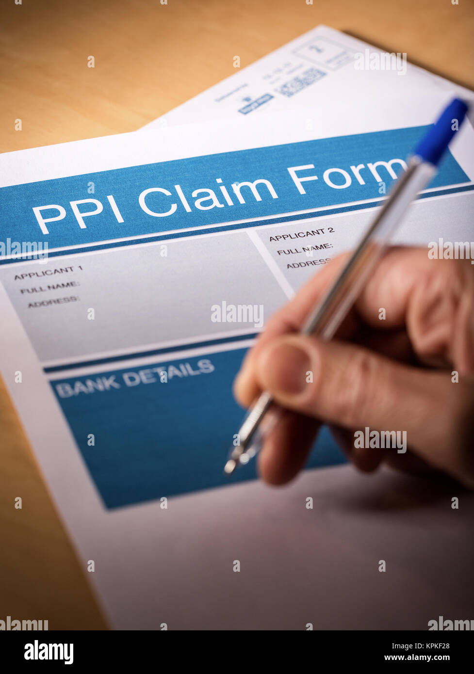 A man filling in a PPI (payment protection insurance) claim form Stock Photo