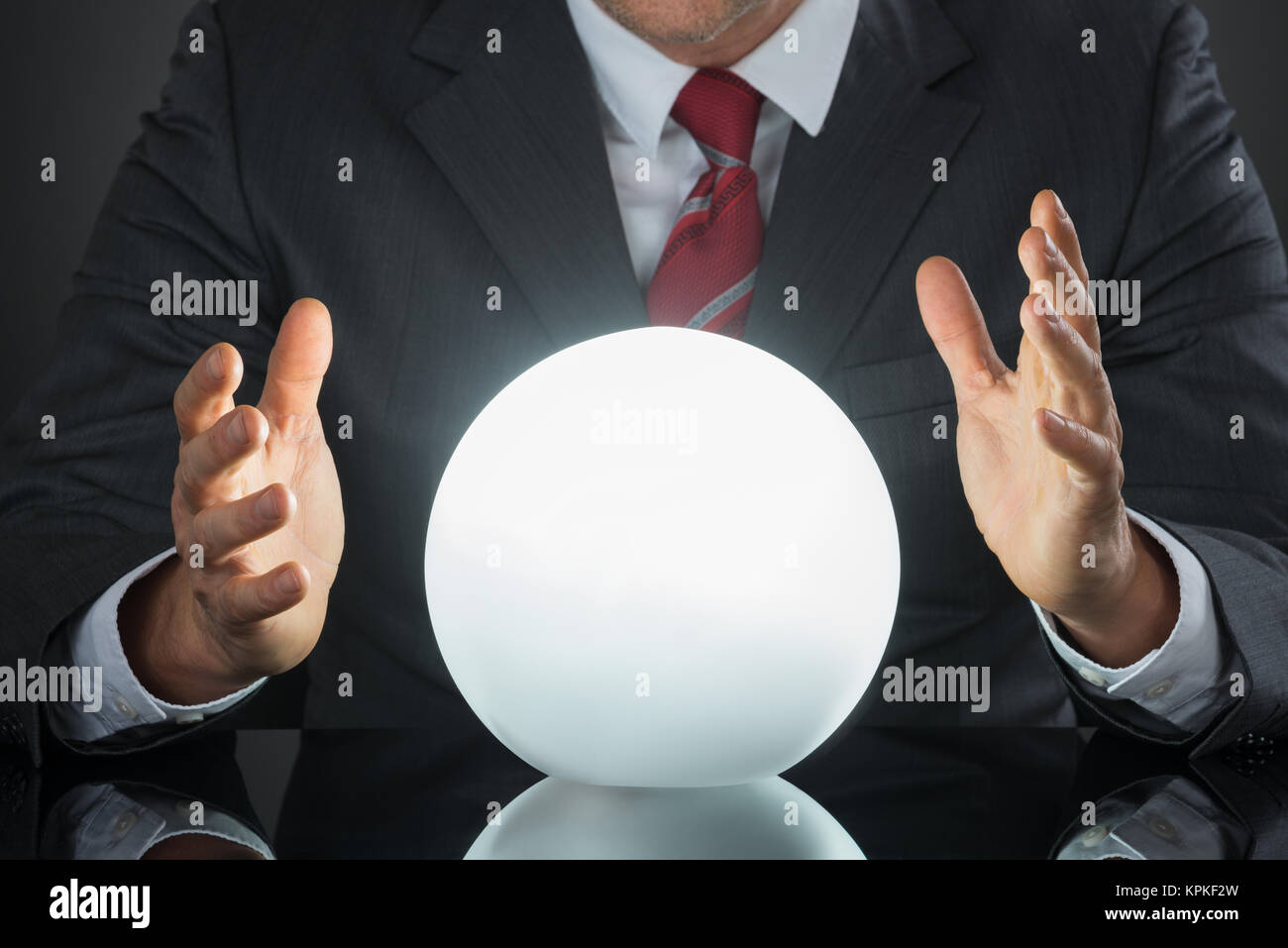Close-up Of Businessman Hand On Crystal Ball Stock Photo - Alamy