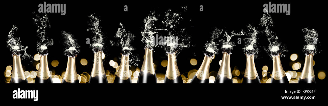 Foaming and splashing champagne bottles panorama Stock Photo