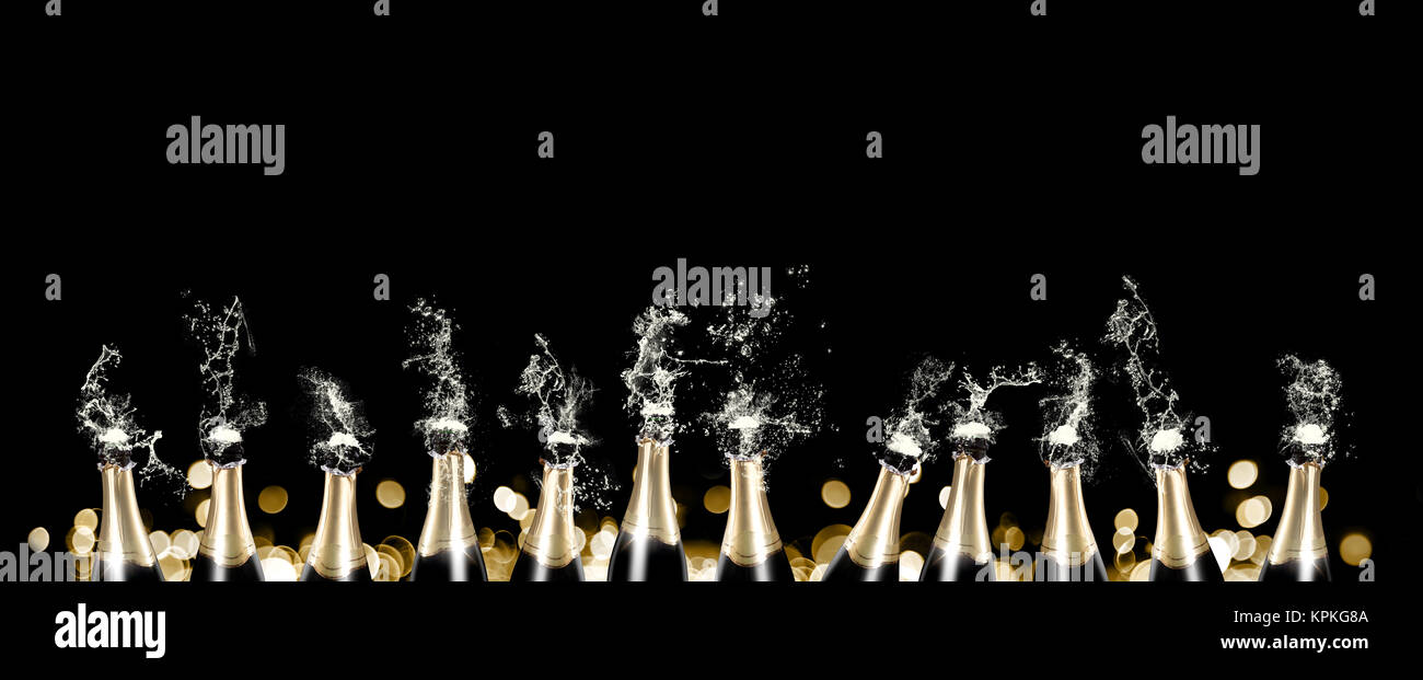 Foaming and splashing champagne bottles panorama Stock Photo